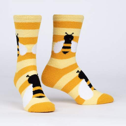 Pair of women's fuzzy yellow and gold striped bumblebee slipper socks shown flat with white-winged bees