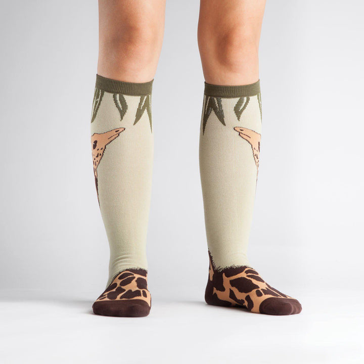 Giraffe knee high socks worn on a model, front view