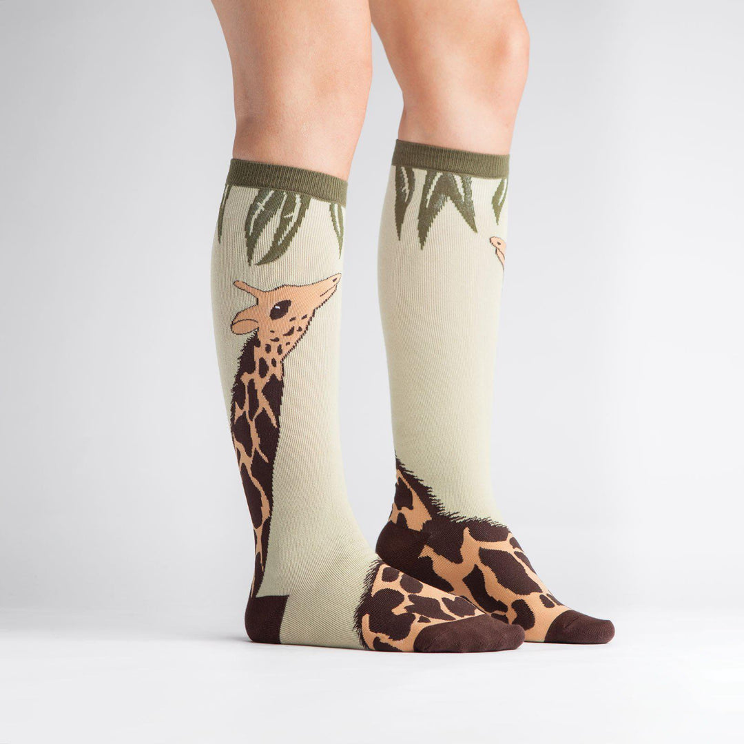 Side view of giraffe knee high socks on a model
