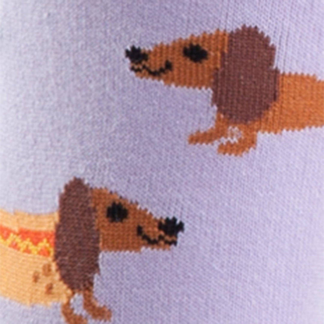 Close-up of cartoon dachshunds on a lavender sock, one wearing a hot dog bun