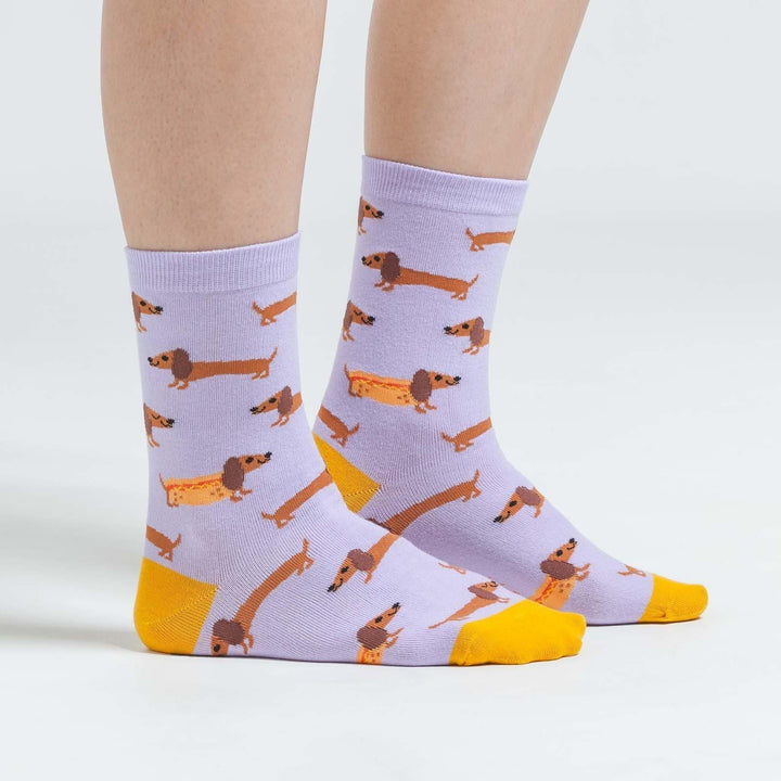 Side view of lavender dachshund crew socks worn on a person&