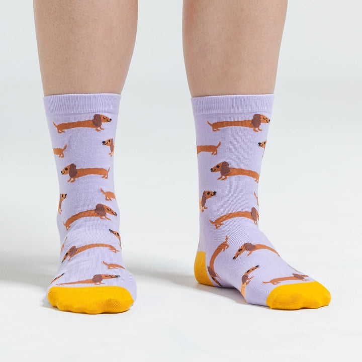 Back view of lavender dachshund crew socks worn on a person&