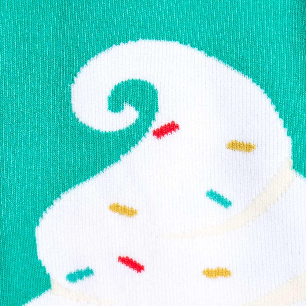 Close-up detail of the ice cream knee-high sock showing the swirled vanilla top and colorful sprinkles on a teal background.