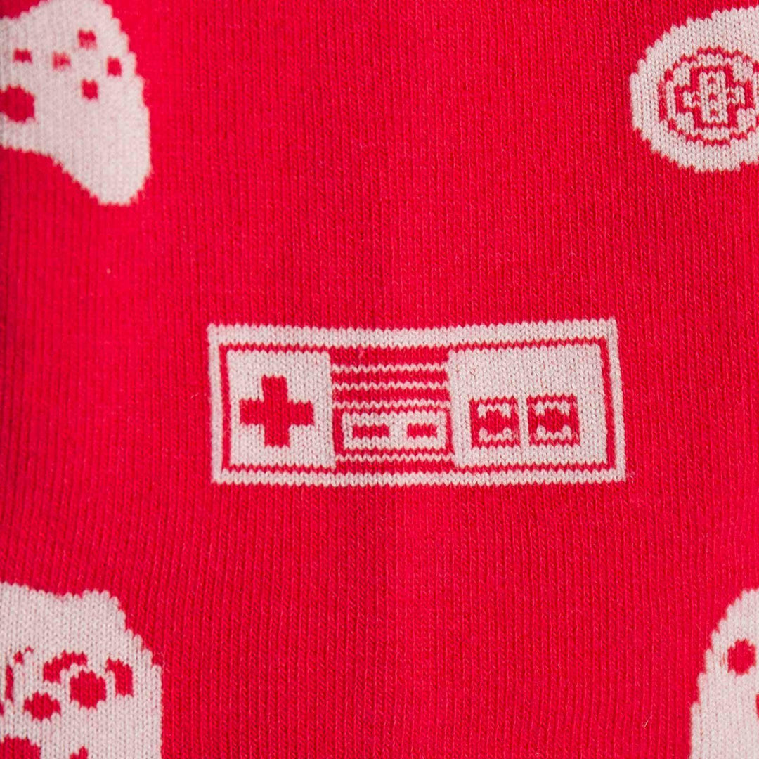 Close-up of a retro rectangular game controller on red