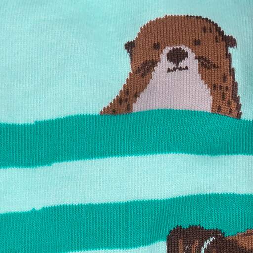Close-up of a single brown sea otter peeking over a teal wave stripe
