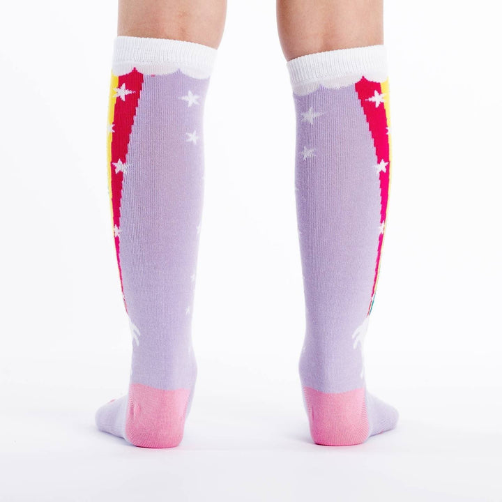 Back view of the lavender rainbow blast knee high socks worn, showing stars and rainbow stripe