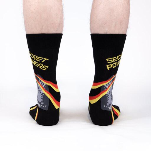 Back view of the Secret Powers cat socks worn, showing the red and yellow streaks and lettering against black