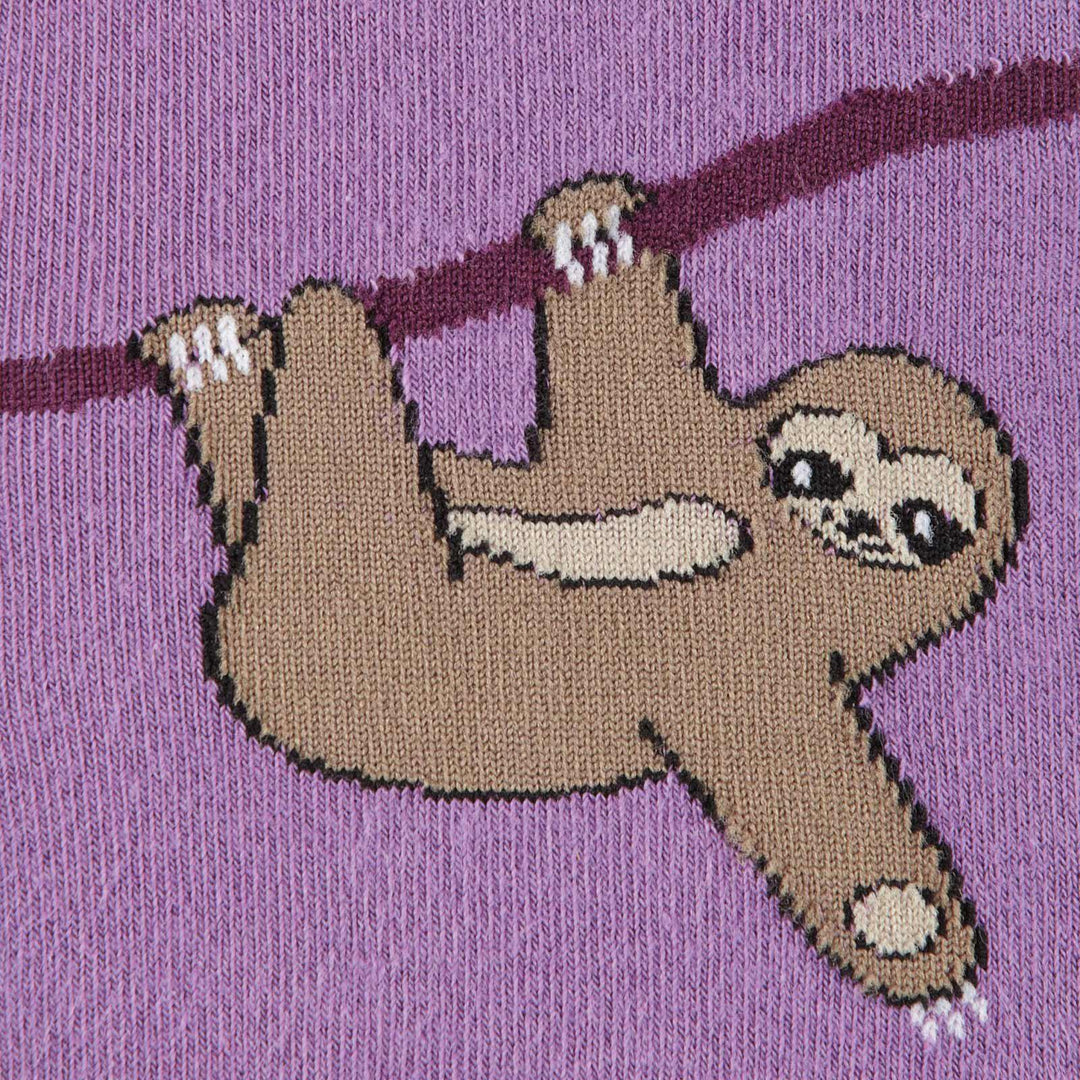 Close-up of a sloth hanging upside down from a branch