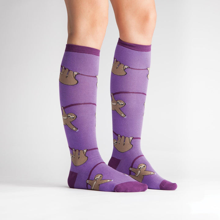Side view of purple sloth knee high socks on a model