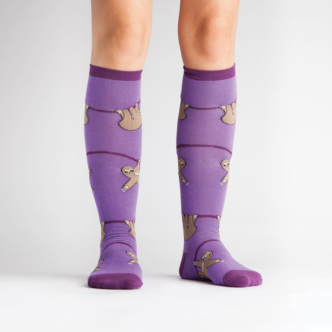 Sloth knee high socks worn on a model, front view