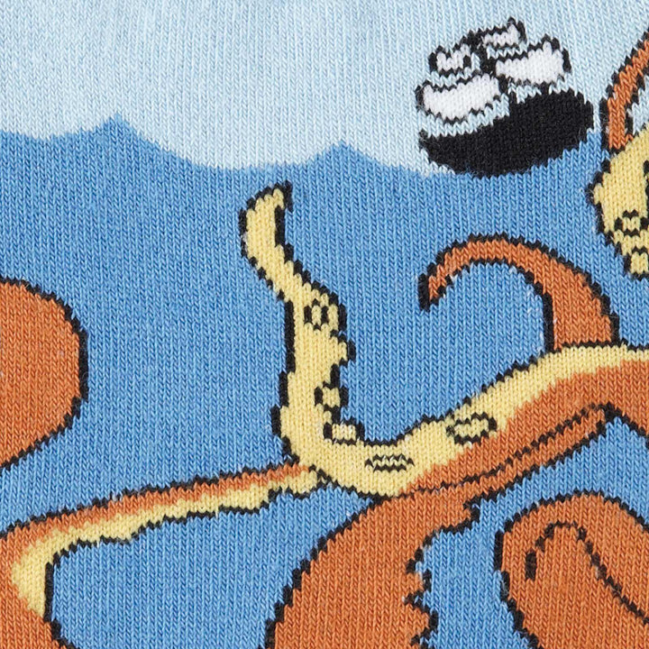 Close-up of the squid crew sock showing the curling orange tentacles, blue waves, and a small ship sailing above.