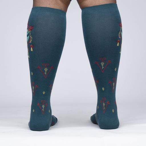 Back view of the Alice knee-highs worn on legs, showing the teal leg with red keys and diamond motifs