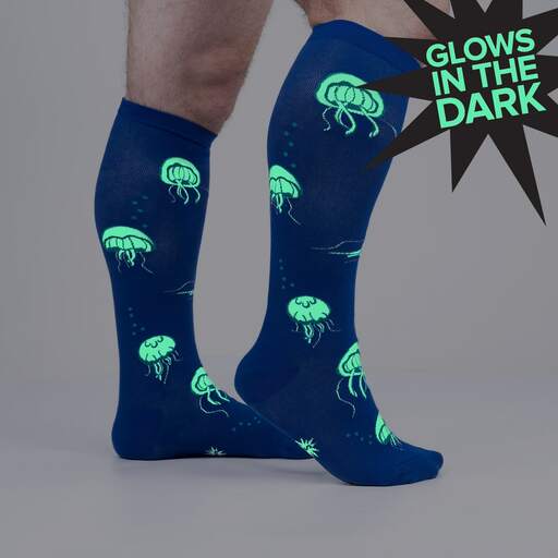 Blue jellyfish knee highs shown glowing green in the dark on legs, marked Glows in the Dark