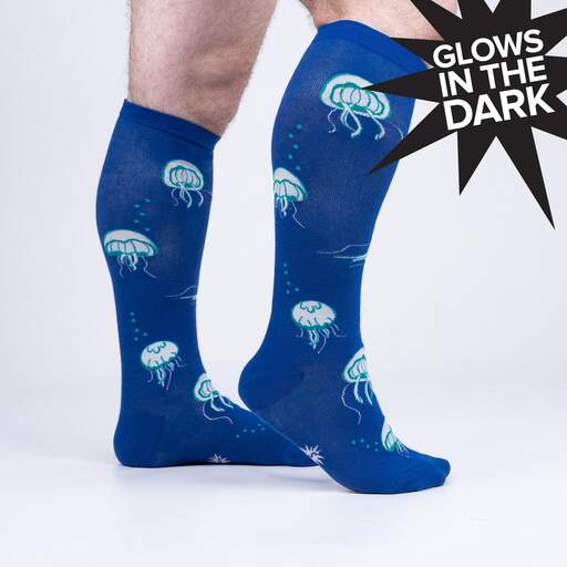 Blue jellyfish knee high socks on legs, side view, with pale teal jellyfish and bubbles, marked Glows in the Dark