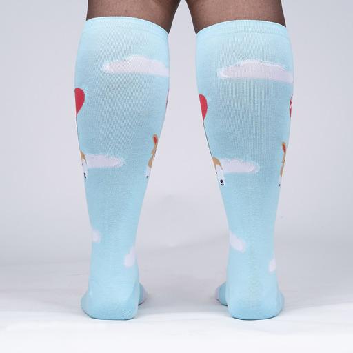 Back view of the corgi knee high socks worn, showing red balloons and clouds across the calves
