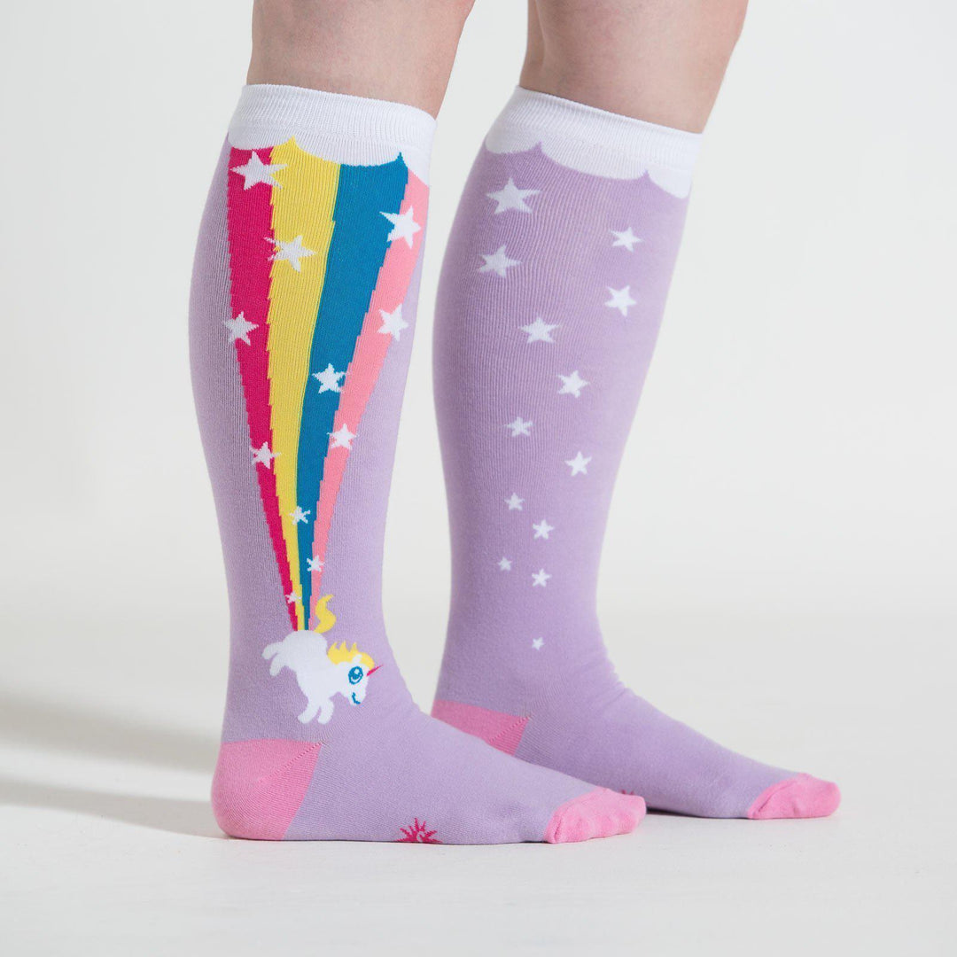 Model wearing lavender unicorn rainbow knee high socks, side view