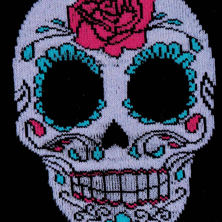 Close-up of a white and turquoise sugar skull with a red rose on a black sock