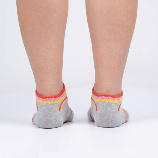 Back view of grey sloth ankle socks on feet showing the striped cuffs and low-cut heel
