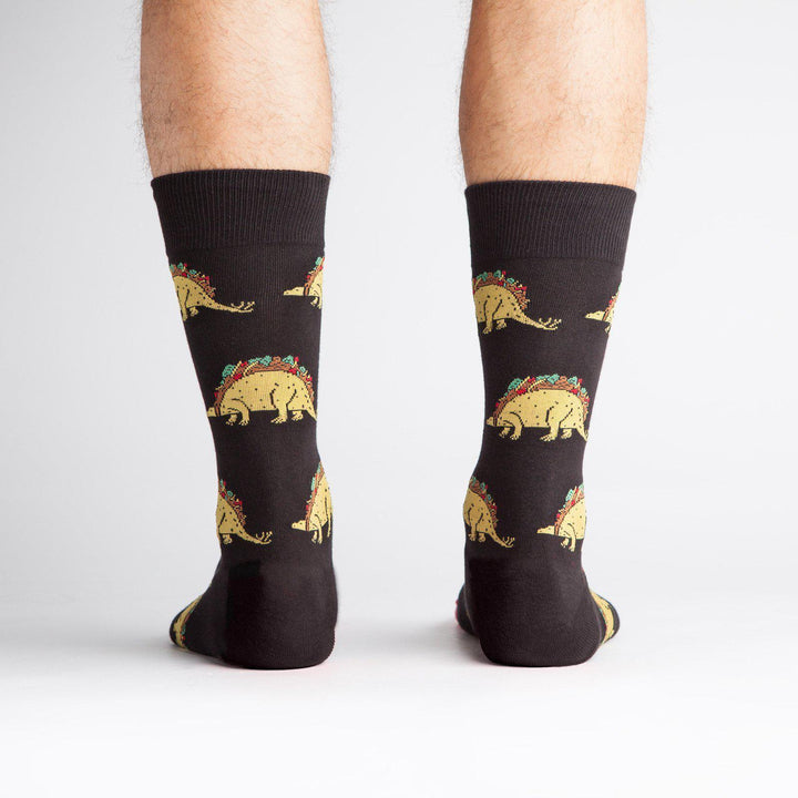 Back view of black taco-dinosaur crew socks on a model