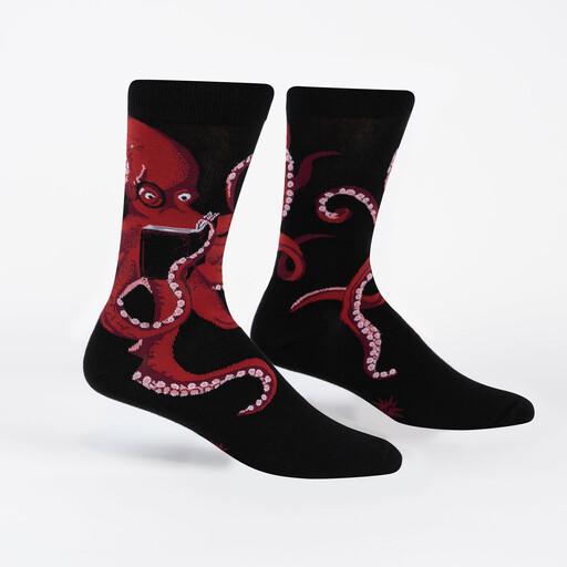 Black octopus crew socks shown flat, one with a reading octopus, the other with trailing tentacles