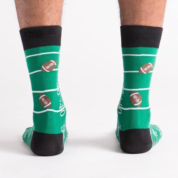 Back view of green football field crew socks on a model
