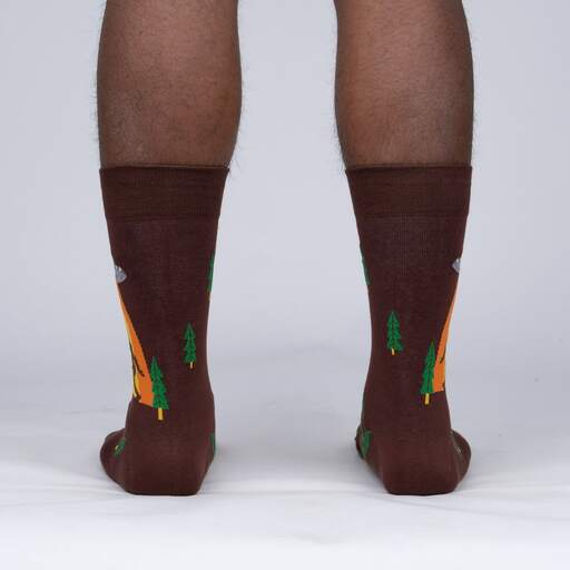 Back view of the Bigfoot crew socks worn, showing pine trees scattered across the brown sock