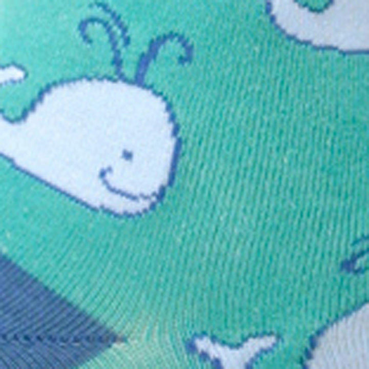 Close-up of a smiling spouting whale on teal fabric