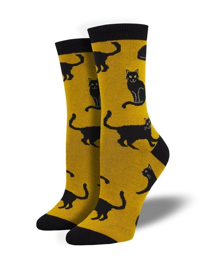 Women's golden-yellow crew socks covered in sleek black cats in various poses, with black cuffs and toes