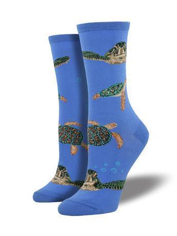 Pair of women's blue crew socks displayed upright, patterned with detailed green and brown sea turtles swimming among small bubbles