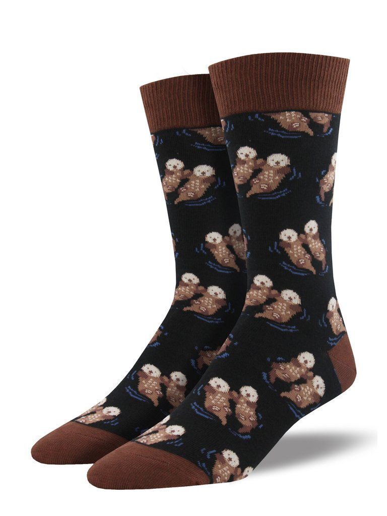 Pair of black men's crew socks with brown sea otters holding hands and blue water ripples, with brown cuffs and toes