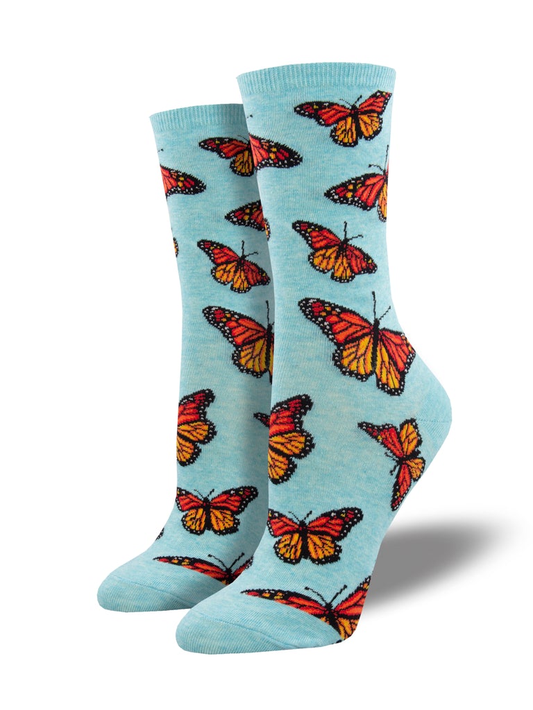 Heathered powder-blue women's crew socks covered in orange and black monarch butterflies