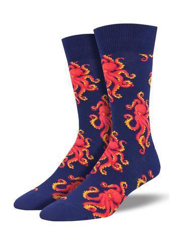 Pair of men's navy crew socks displayed upright, covered with vivid red-orange octopuses and curling tentacles