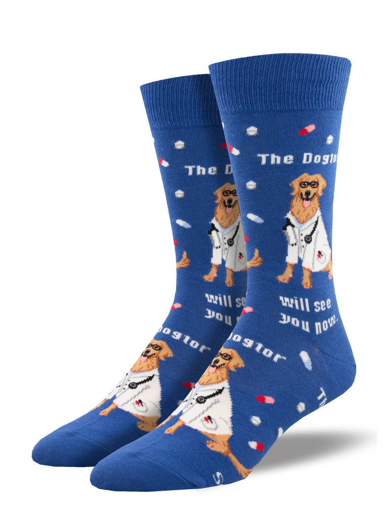Blue men's crew socks with a golden retriever in a lab coat and glasses, scattered pills, and the words The Dogtor will see you now