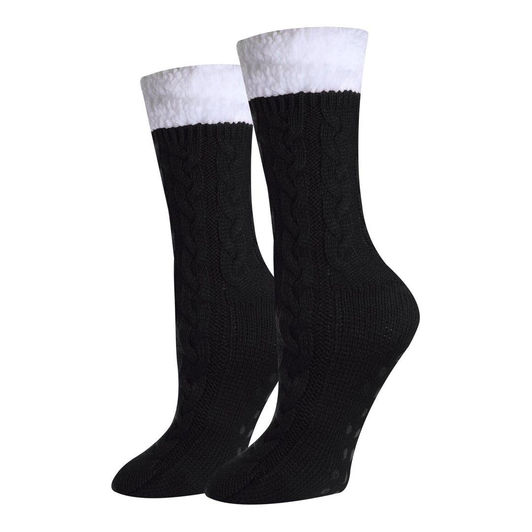 Women's solid black sherpa-lined cable-knit crew socks, flat front view with white fluffy cuff and gripped sole