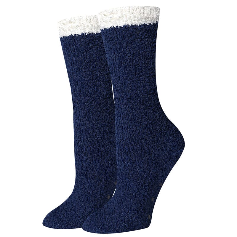 Women's solid navy fuzzy crew socks, flat front view with cream cuff and non-slip dotted sole