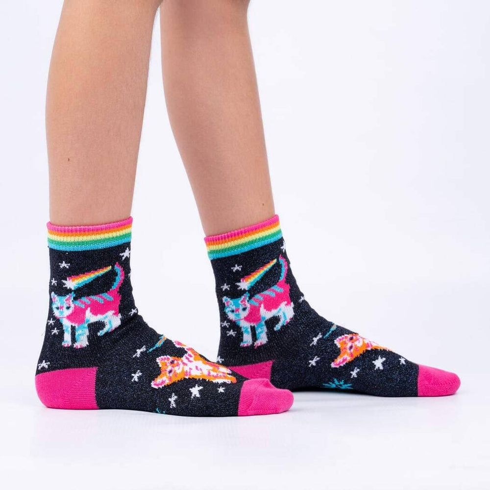Child wearing the navy space cat socks with rainbow kitties and stars