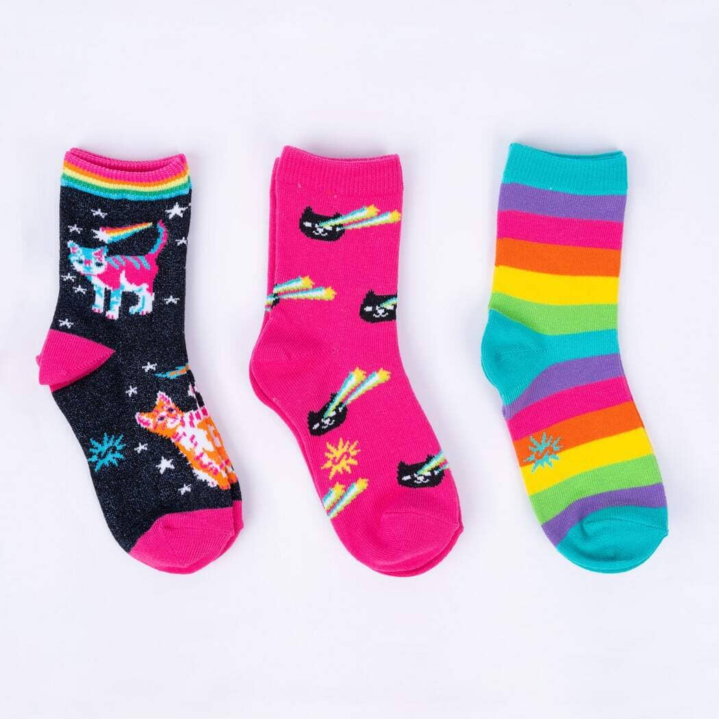 Three kids' crew socks laid flat: navy with rainbow space cats, pink with comet cats, and rainbow stripes