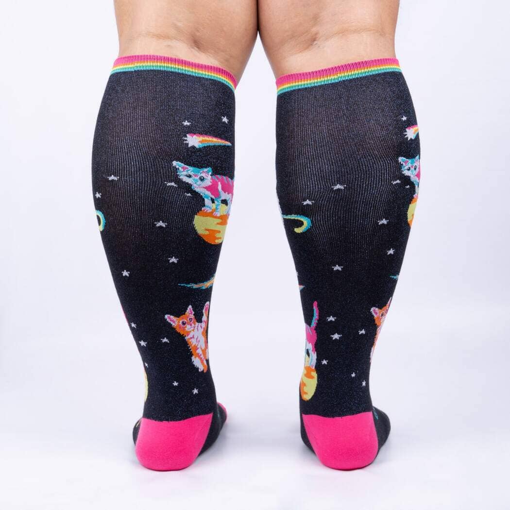 Back view of the space cat knee highs worn on legs, showing the cosmic pattern and pink heels