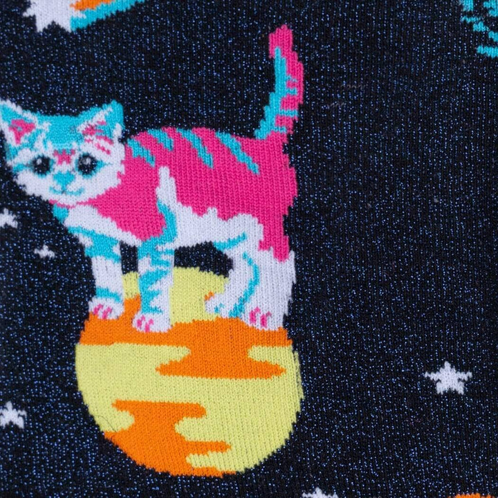 Close-up of a pink-and-white striped cat standing on a yellow planet against a starry sky