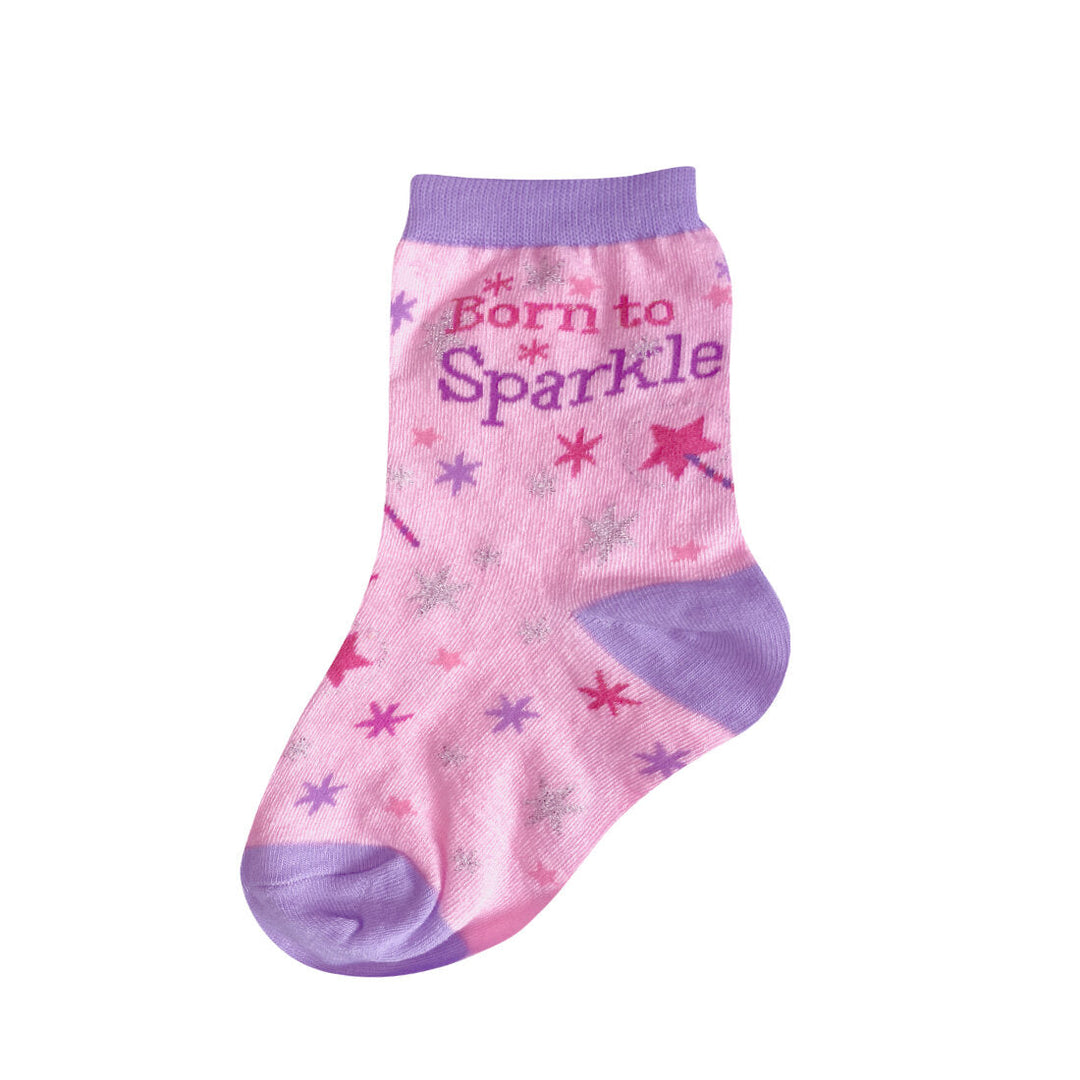 Pink kids' crew sock with purple cuff, heel, and toe reading Born to Sparkle among glittery pink, purple, and silver stars and wands