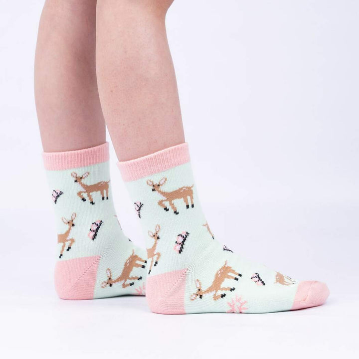 Side view of child wearing the mint fawn-and-flower crew socks