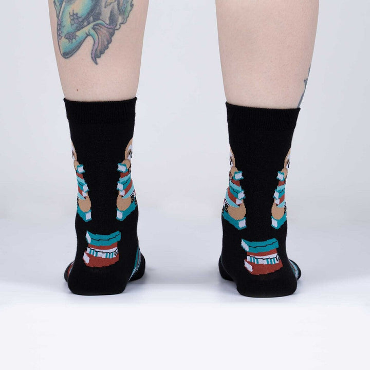 Back view of the sloth book crew socks worn, showing book stacks on the heel