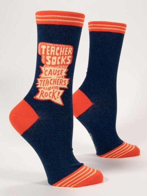 Women's navy crew socks with orange stripes and cream lettering reading Teacher Socks 'Cause Teachers Rock!