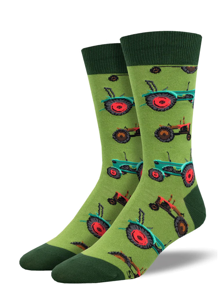 Men's green crew socks patterned with red, blue, and orange vintage tractors and dark green cuff, heel, and toe
