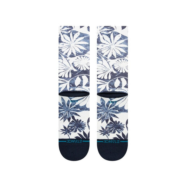Front-leg detail of the Waikaloa socks with faded indigo flowers and the Stance logo at the cuff