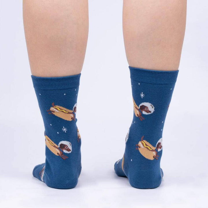 Back view of the navy socks worn on legs, showing the dachshund hot dogs and stars