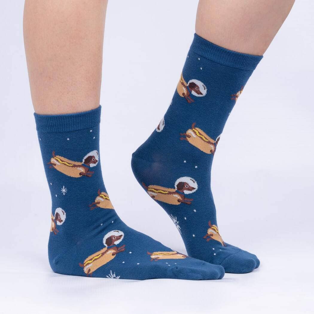 Side view of the space weiner dog socks worn on legs, showing the floating hot dog dachshunds