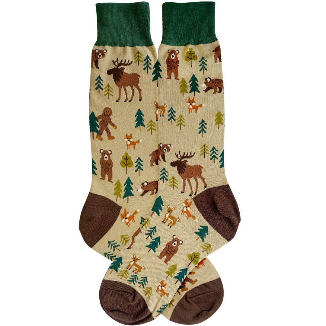 Cream men's crew socks with green cuff and brown heel, patterned with bears, moose, foxes, deer, evergreens, and a walking Bigfoot